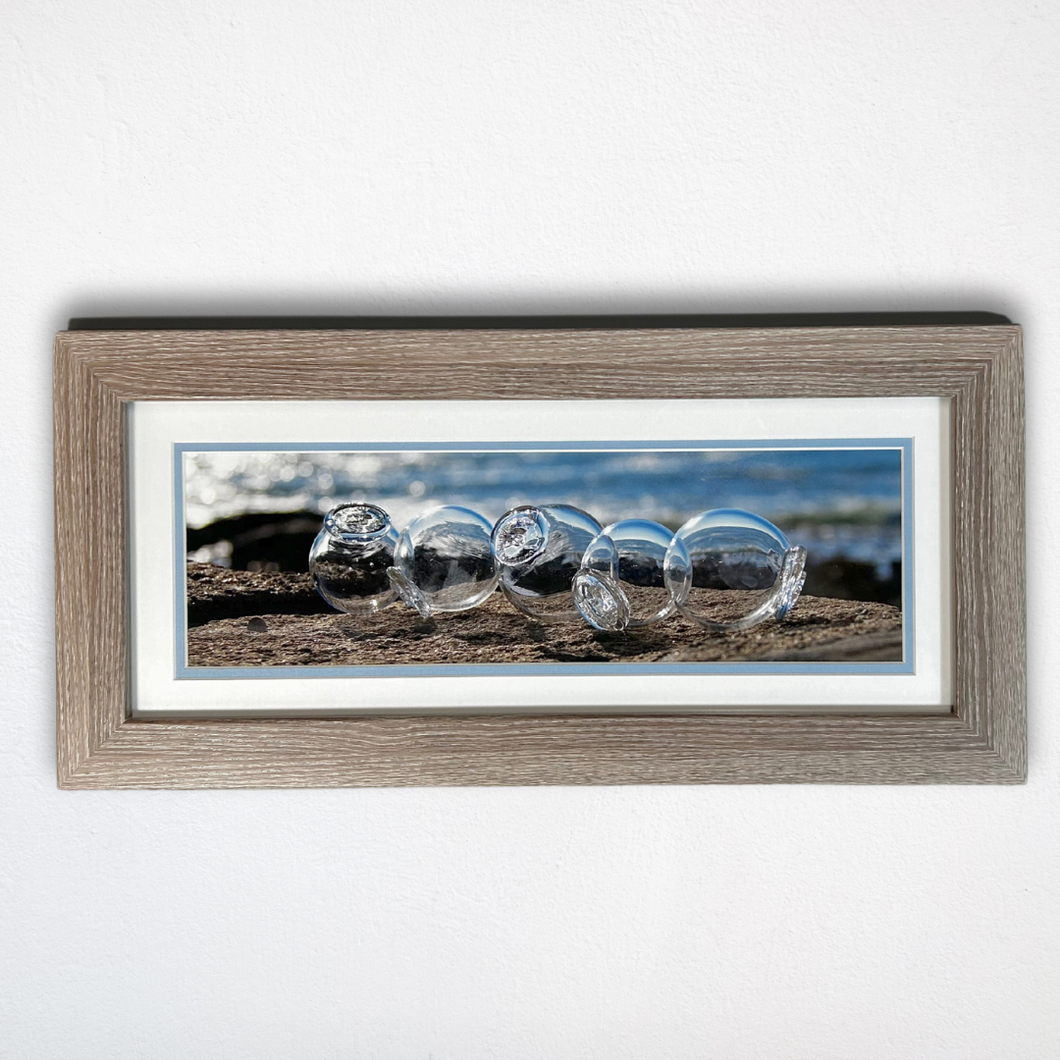 5 Clear Glass Floats on Beach Framed Photo