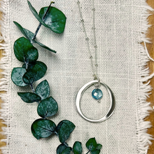 Load image into Gallery viewer, Sterling Silver Organic Circle Necklace with Blue Topaz Drop
